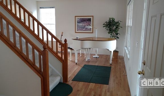 Baby grand and acoustic guitar in front room