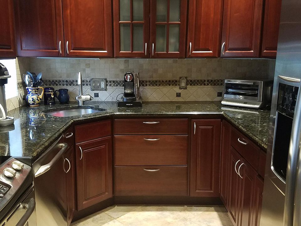 Kitchen with recessed lighting and cherry cabinetry