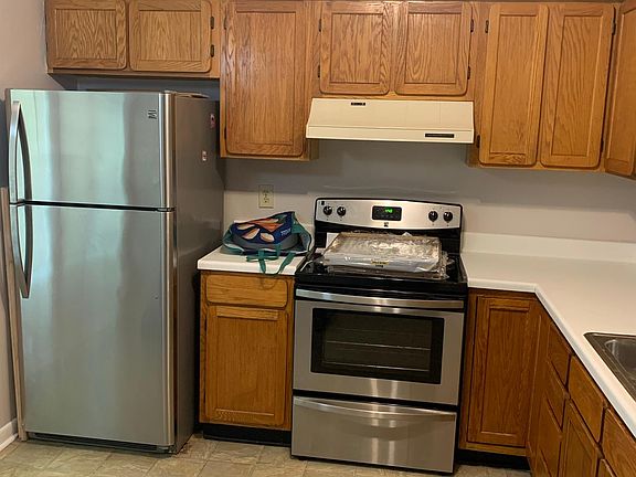 Kitchen with all stainless appliances. Glass top electric range.
