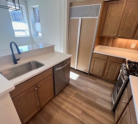 First floor brand new kitchen with all new appliances: Subzero refrigerator, stove, microwave, and dishwasher