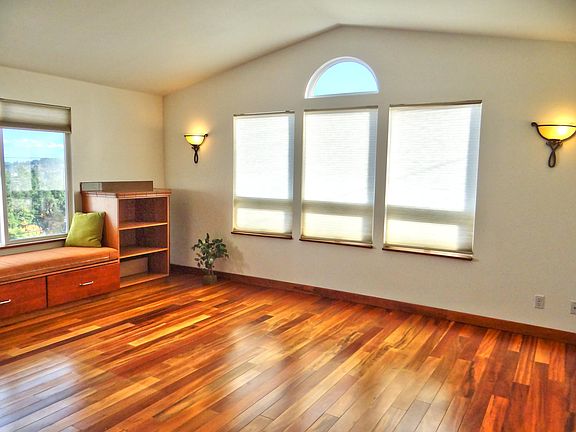 Living with cozy seating area facing water and mountain views.