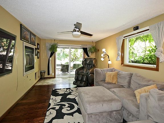 Living room has see-through fireplace and heated floors by the sliding door.