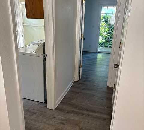 Hallway looking into downstairs bedroom and laundry room