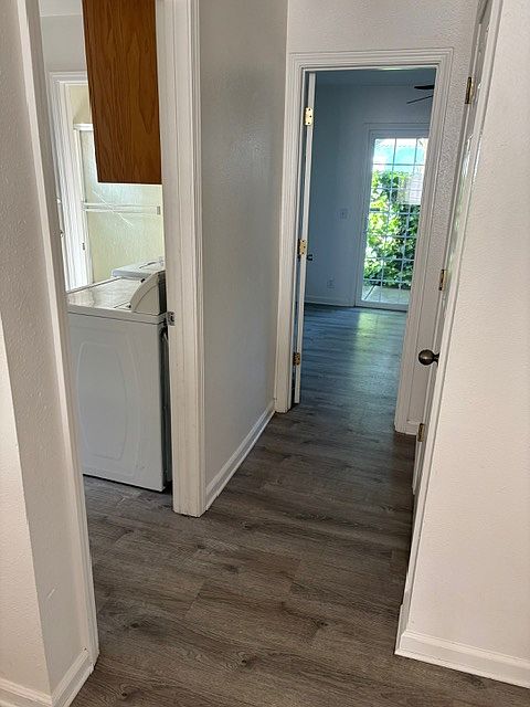 Hallway looking into downstairs bedroom and laundry room