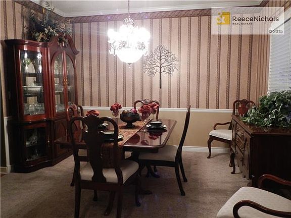 Large formal dining room is ready for your next dinner party.