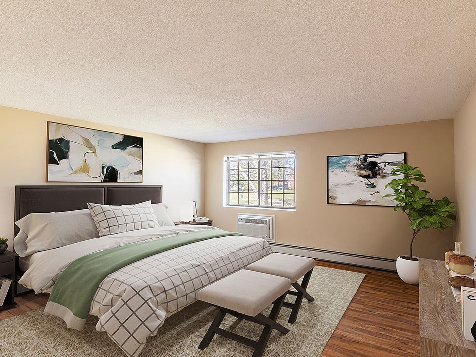 Large bedroom with wood flooring and ample natural light