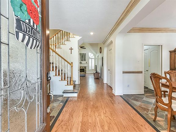 Lovely entry with leaded glass front door and refinished solid wood floors that welcome you in.