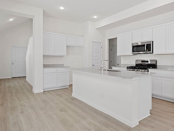 Kitchen in the Elm home plan by Trophy Signature Homes - REPRESENTATIVE PHOTO