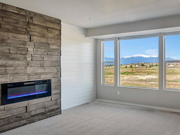 Unobstructed views of Pikes Peak and open space through oversized windows. And no neighbors to stare at! Adjust the custom fireplace to the color scheme and heat level of your choice.