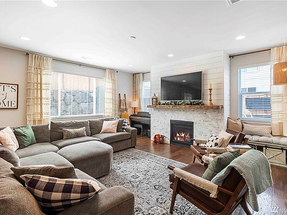 Huge family room with custom brick surround, reclaimed wood mantle and shiplap accents. 