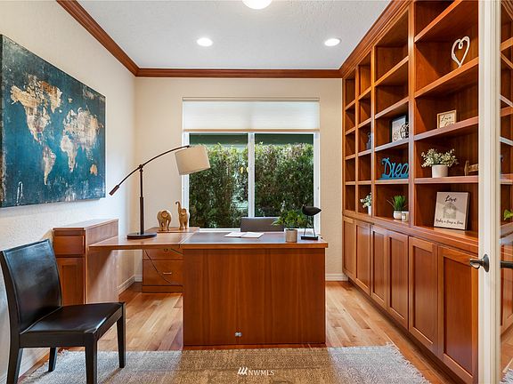 Home office offers built in cabinets and matching desk is included. On the right side of the picture you can see one of the glass French doors that you can close to have privacy.