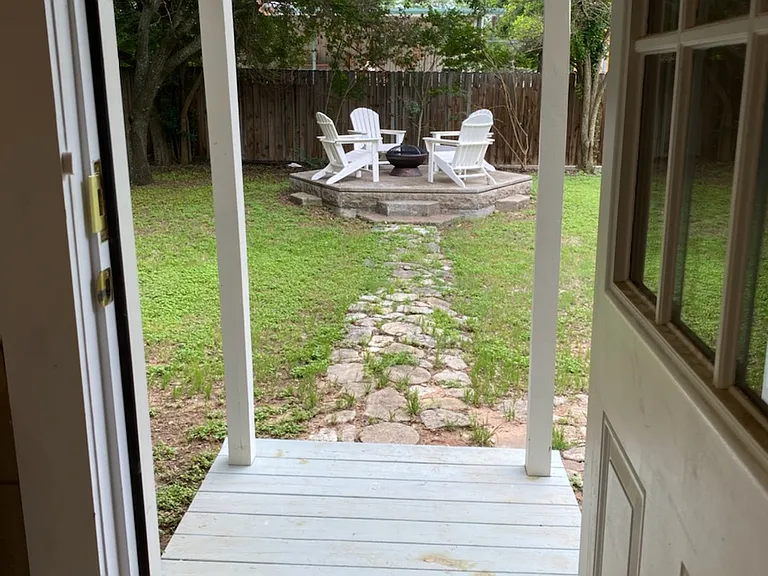 Kitchen door leads to an elevated patio with a fire pit.