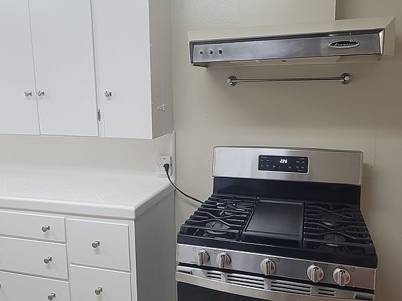 Kitchen with great storage and a vent hood for the stove.