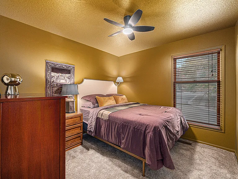 Unwind in a comfortable bedroom designed for two, complete with essential furnishings that create a practical and relaxing everyday space.