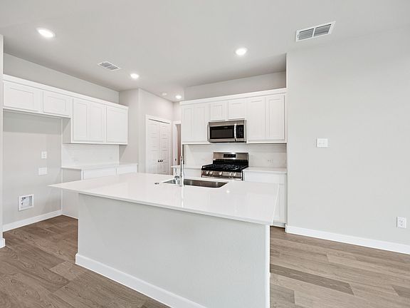 Kitchen in the Mesquite home plan by Trophy Signature Homes - REPRESENTATIVE PHOTO