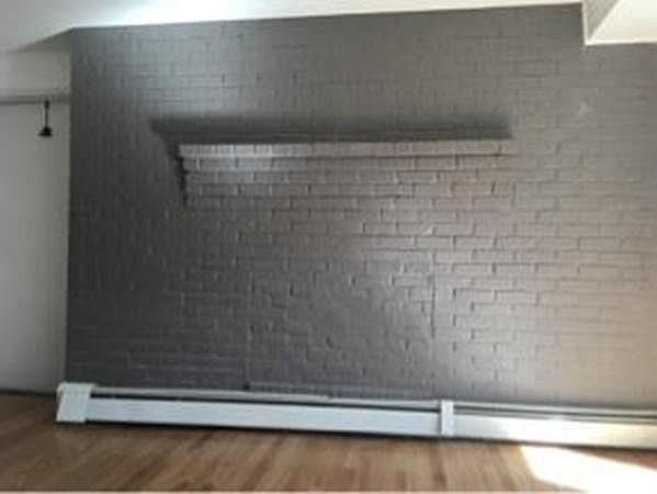 Real brick accent wall with shelf