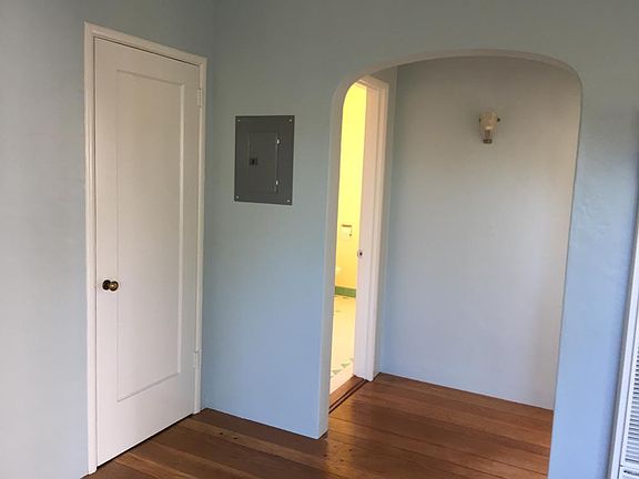 From the living room, l to r, a closet, the door to bathroom and the door to bedroom.