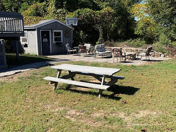 Backyard with stone patio and firepit