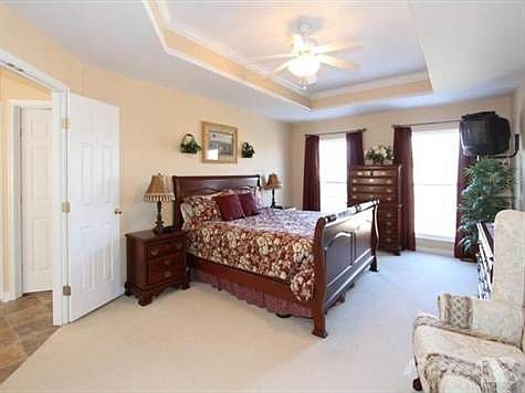 The owners suite has recessed ceilings with crown moldings & ceiling fan. Enjoy the large French doors to the private bath.
