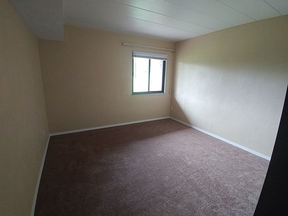 Bedroom with window overlooking green space