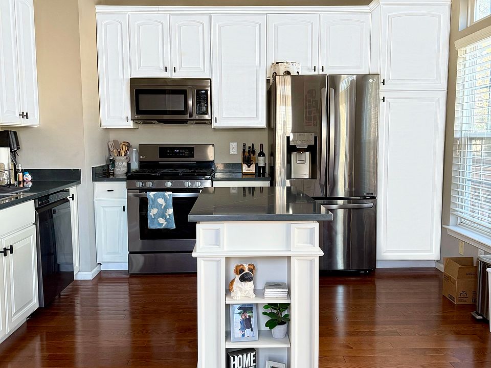 Open concept kitchen with island, movable coffee station, and updated appliances