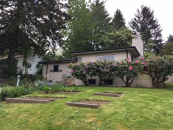 Garden beds and flowers out front.