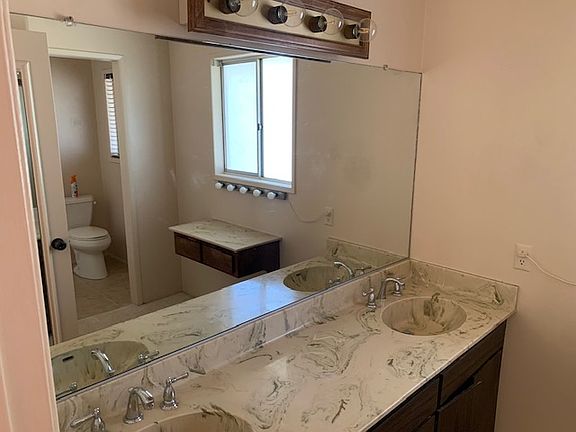 Master bathroom has additional make-up table with additional lighting. Also features extra closet for clothes storage or linen storage.