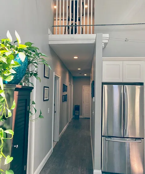 Hallway to back entrance with view of loft.