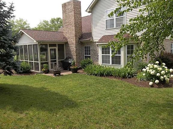 Exterior Back. Beautifully landscaped rear yard with remodeled screen porch and patio.