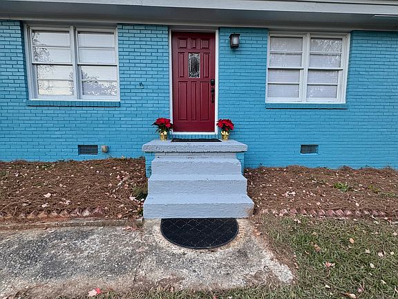 This home exudes curb appeal with its freshly painted blue brick exterior and eye-catching red front door. Nestled on a quiet cul-de-sac, the welcoming design sets the tone for the stylish updates found throughout the property.