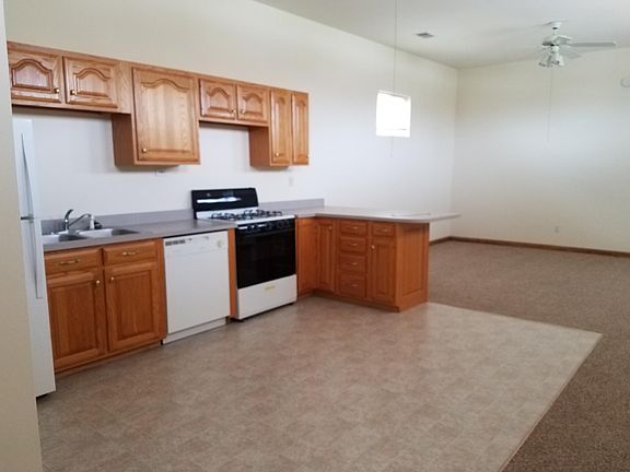 Extended countertop for stool seating and dishwasher.