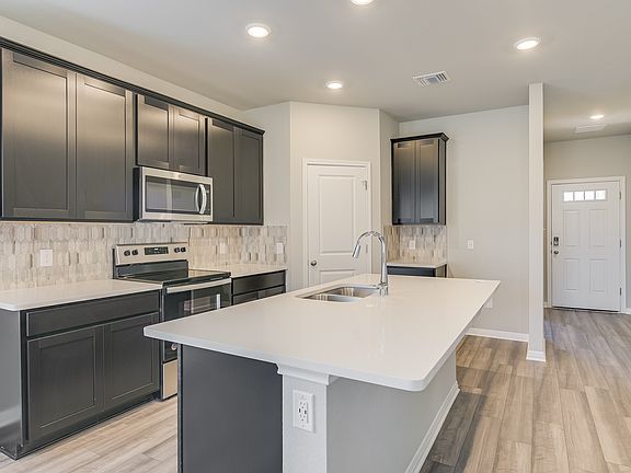 This home offers an open concept kitchen with espresso-colored cabinets.