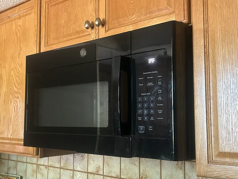 Microwave in kitchen above stove