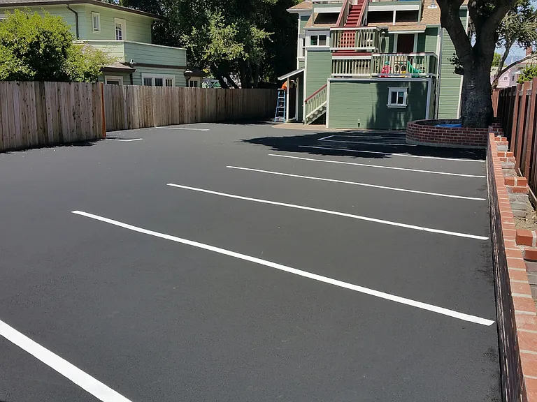 Parking with decorative brick wall and wood fencing