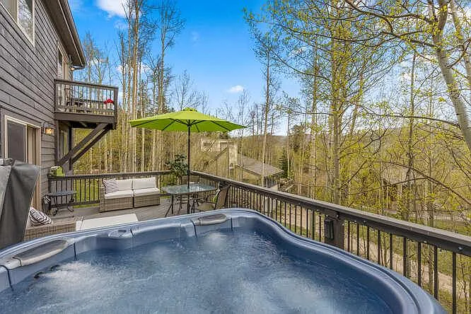 Back deck off of main level, with hot tub and outdoor furniture