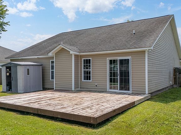 Large fenced in backyard with deck