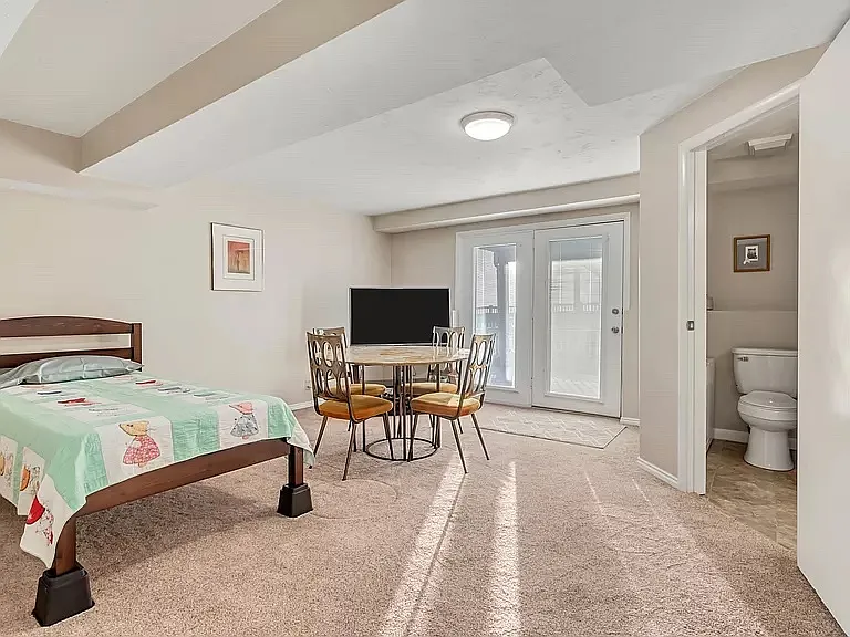 spacious basement bedroom with ensuite bath (shower only) - doors walk out to backyard