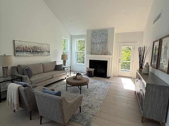 Living room with high ceiling and fire place
