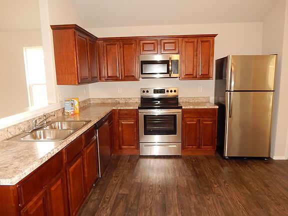 Oversized kitchen features stainless steel appliances. Refrigerator included.