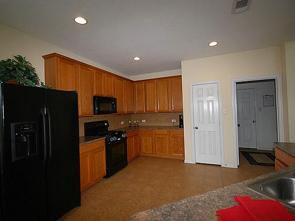 Open kitchen with tile flooring and 42" cabinets.