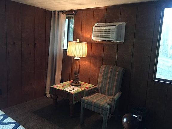 THIS IS THE SITTING AREA IN THE MASTER BEDROOM UNDER THE 8,000 BTU A/C. REMOTE W/OPERATING INSTRUCTONS IS ON THE TABLE. THIS IS A CORNER BEDROOM W /WINDOWS ON TWO SIDES.