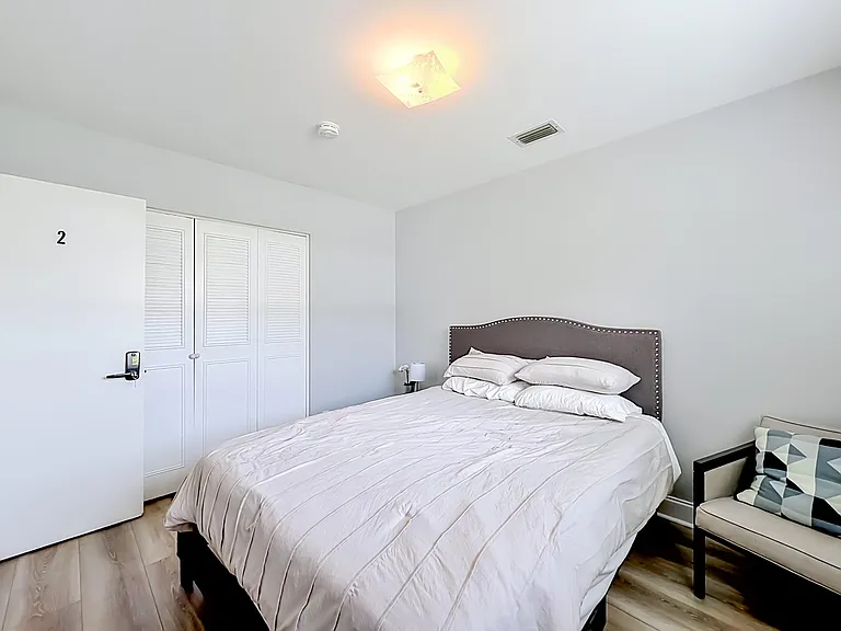 Well-proportioned bedroom with a comfortable bed setup, closet storage, and easy-care flooring for everyday living.
