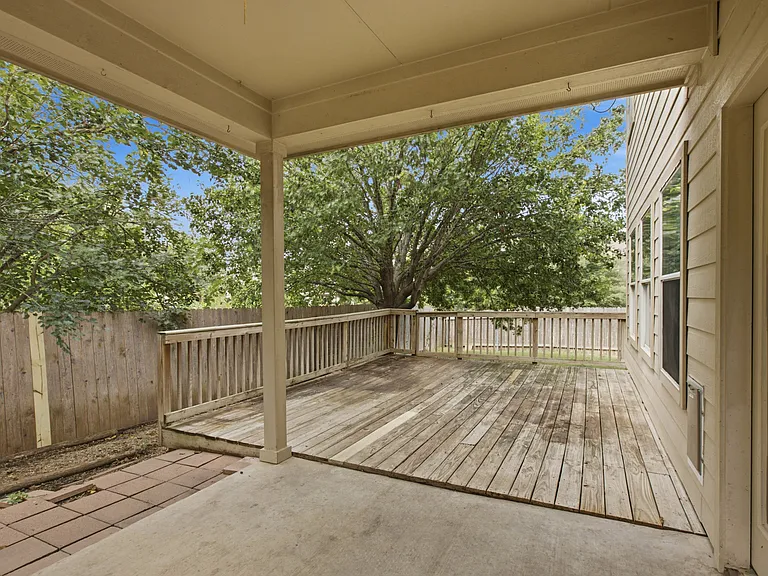 Large wooden deck, covered patio and large grassy section