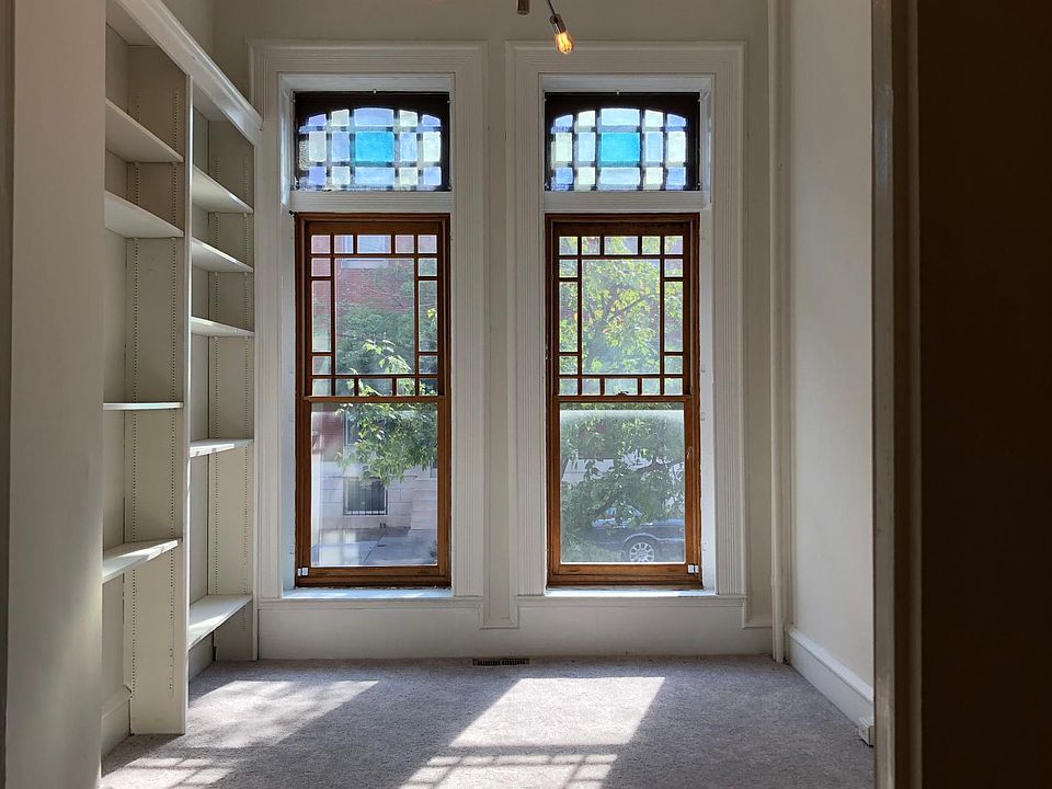 Bright beautiful bedroom with historic stain glass windows