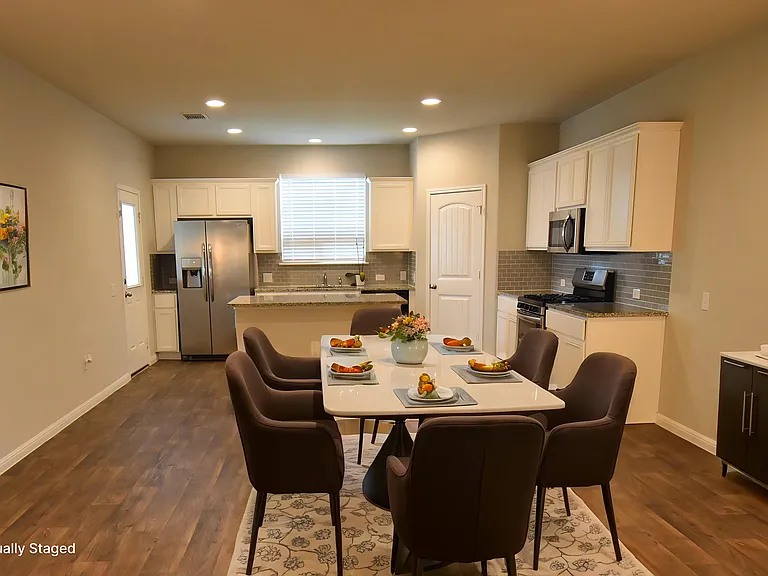 Virtually Staged dinning room with the kitchen in the background