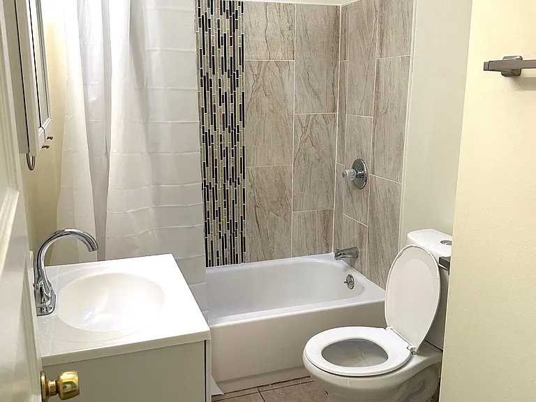Remodeled and modern ceramic tile bath with skylight