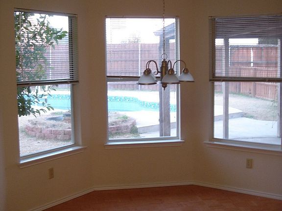 Eat in area with view of huge backyard & pool