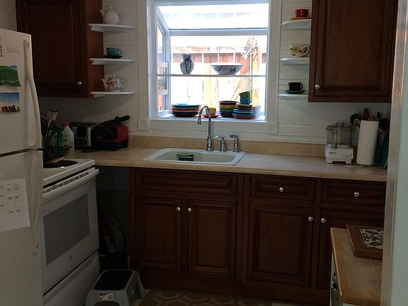 cherry kitchen cabinets, crown moldings ,garden window .new