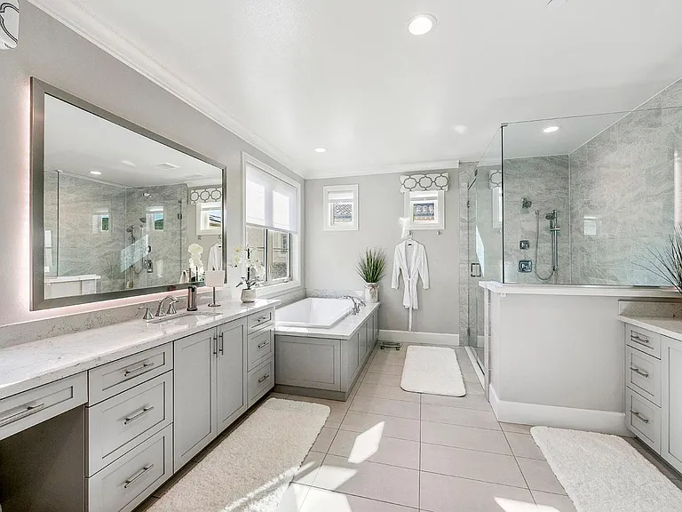 LUXURY is the word that describes this Spa like first class primary bathroom! Giant tub. Oversized shower. Dual vanities. Custom backlit mirrors in a choice of colors to start your day off perfectly!