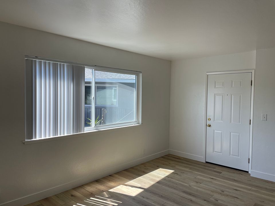 View of Living room and front door, from kitchen
